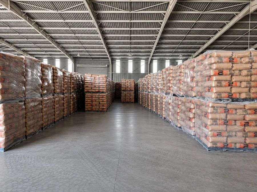 Aisle between wrapped pallets of cement in the Hard Rock Cement warehouse